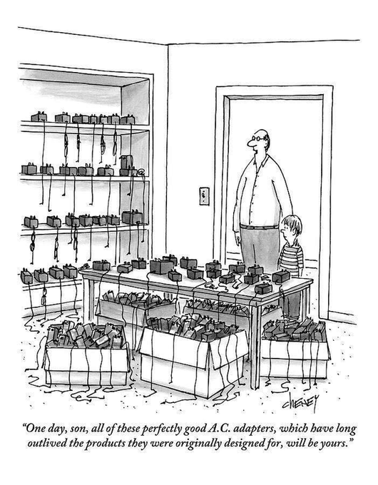 A Tom Cheney comic. A father and his son stand in the doorway of a room that is full of organized A.C. adapters with hanging cords. The caption is, "One day, son, all of these perfectly good A.C. adapters, which have long outlived the products they were originally designed for, will be yours."